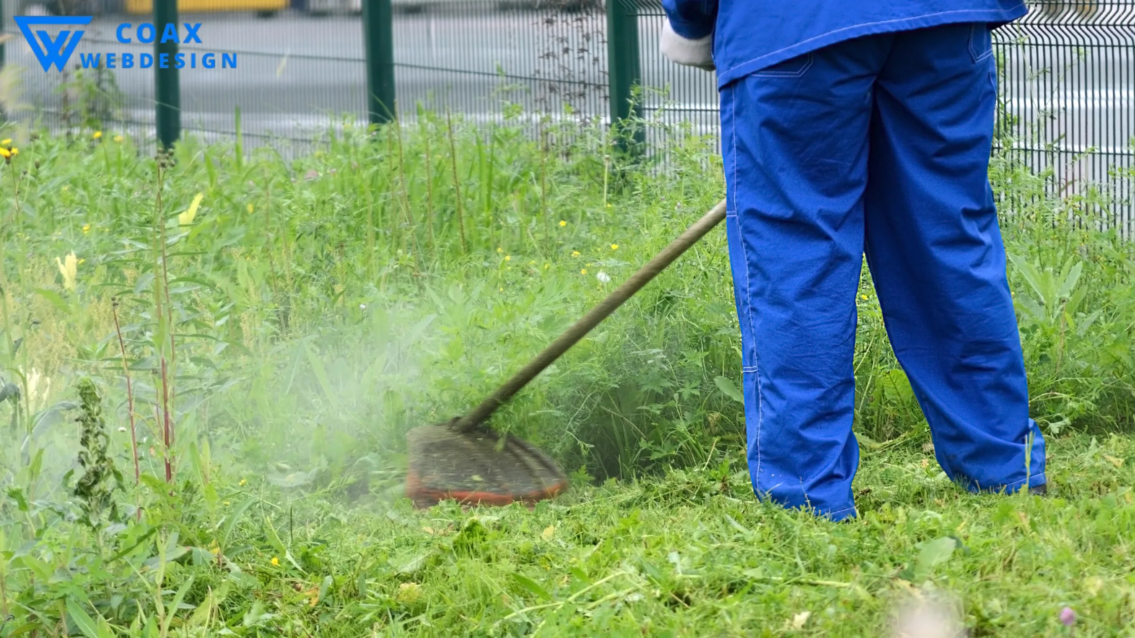 "Worker using a trimmer to cut wet grass, raising the question: can you cut wet grass safely?"